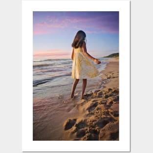 Little girl standing on beach Posters and Art